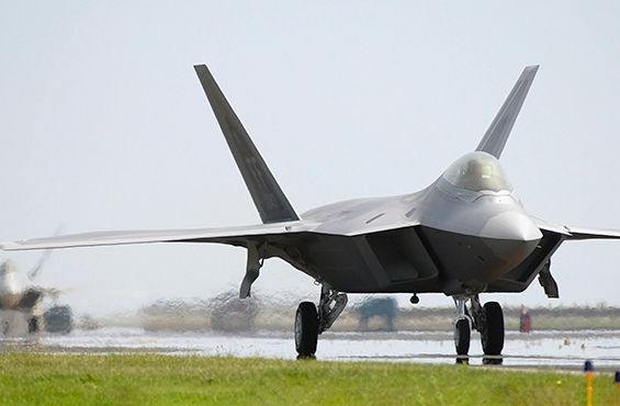 Photo of an F-22 Raptor fighter jet taxiing on a runway.