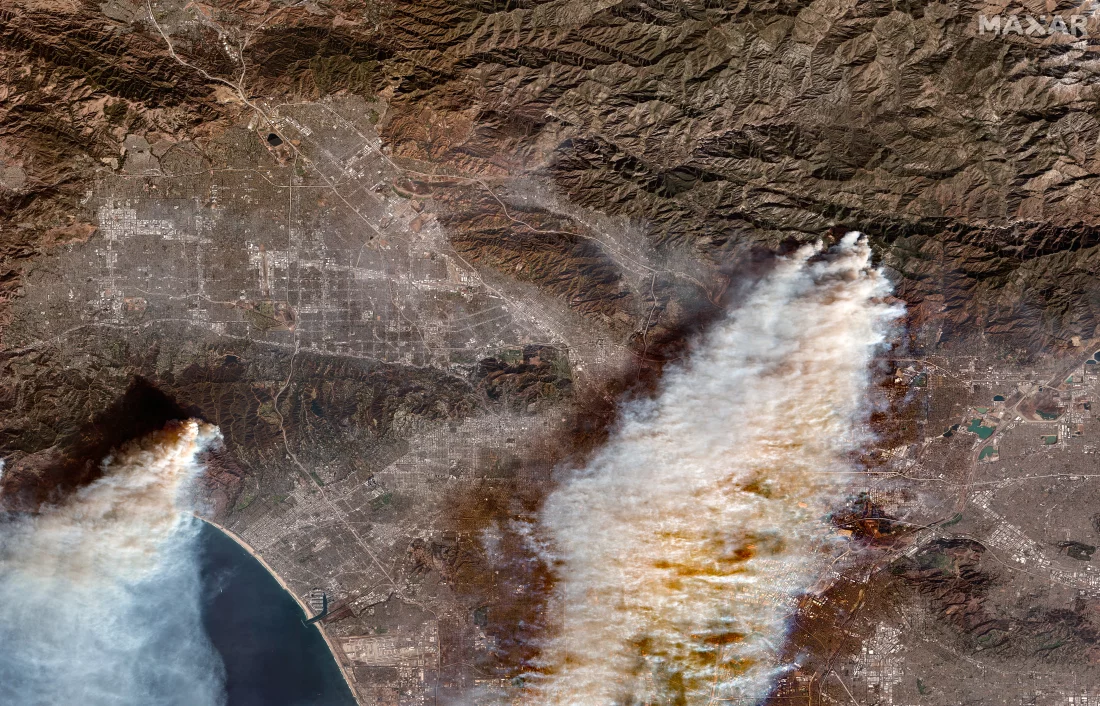 The Palisades and Eaton wildfires are visible in this satellite image taken on Thursday.